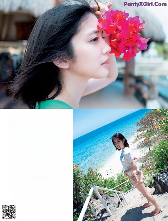 A woman holding a bunch of flowers near the ocean.