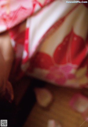 A woman in a blue and pink kimono posing for a picture.