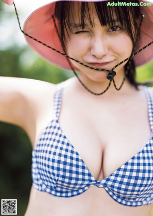 A woman in a white dress posing for the camera.