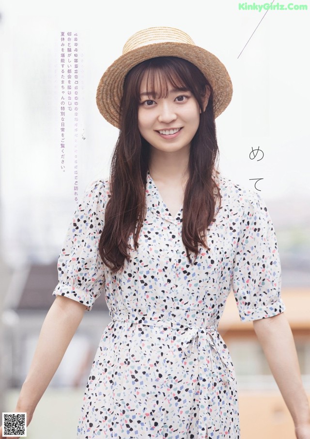 A woman in a white dress and a straw hat.