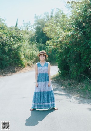 A woman in a red and white bikini running down a road.