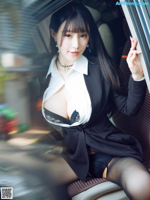 A woman sitting in the back seat of a car wearing black stockings.