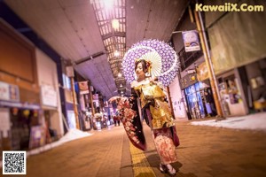 Two women in kimonos posing for a picture. 