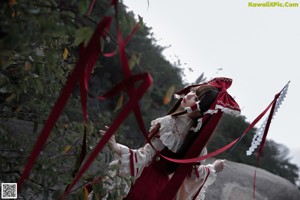 A woman in a red and white dress holding a knife.