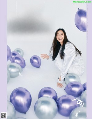 A woman in a white shirt and shorts posing for a magazine.
