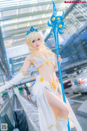 A woman in a white outfit holding a blue sword.